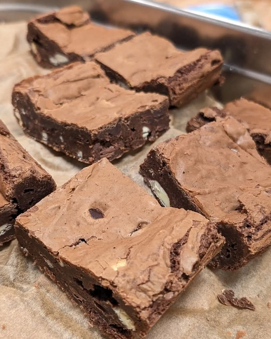 Brownies cut into squares on a baking tray